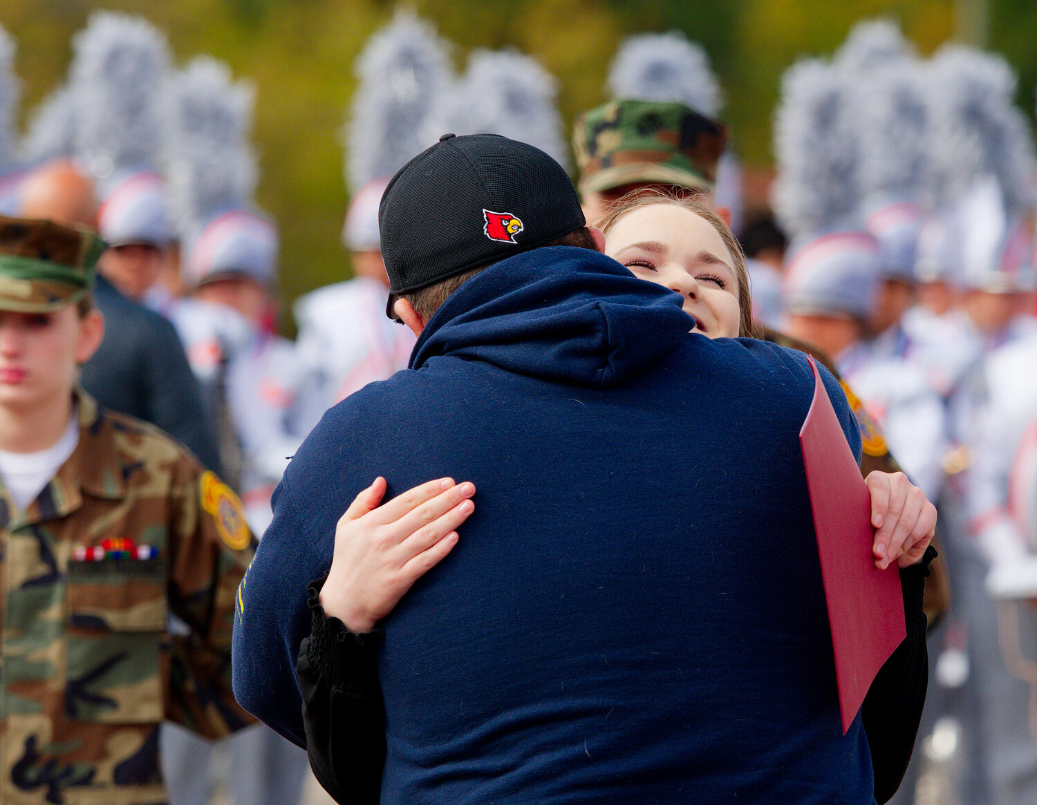 Autumn and Timothy Grosskopf embrace after she delivered her essay at Saturday’s ceremony following the Mineola Veterans Day Parade.